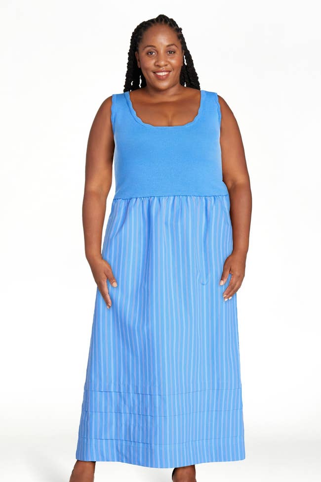 Person wearing a sleeveless dress with a fitted top and striped skirt, suitable for casual outings