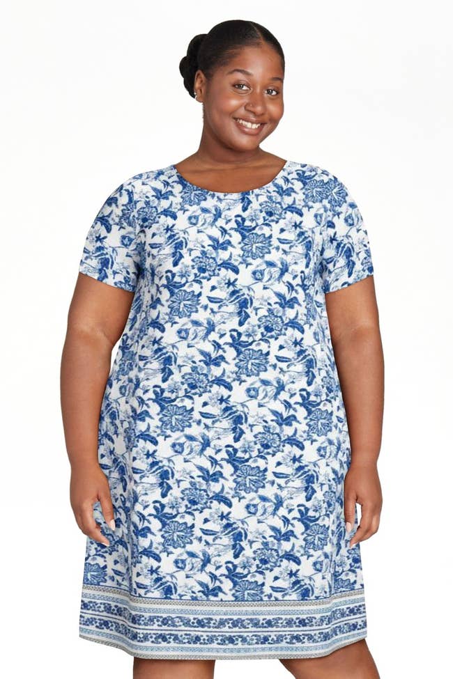 Person wearing a floral patterned dress, smiling