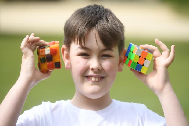 10-year-old boy races giant tortoise in Rubik's Cube challenge