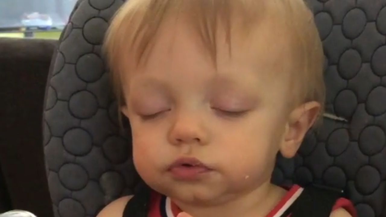 Adorable young child dozes off while snacking charming sleep-eating