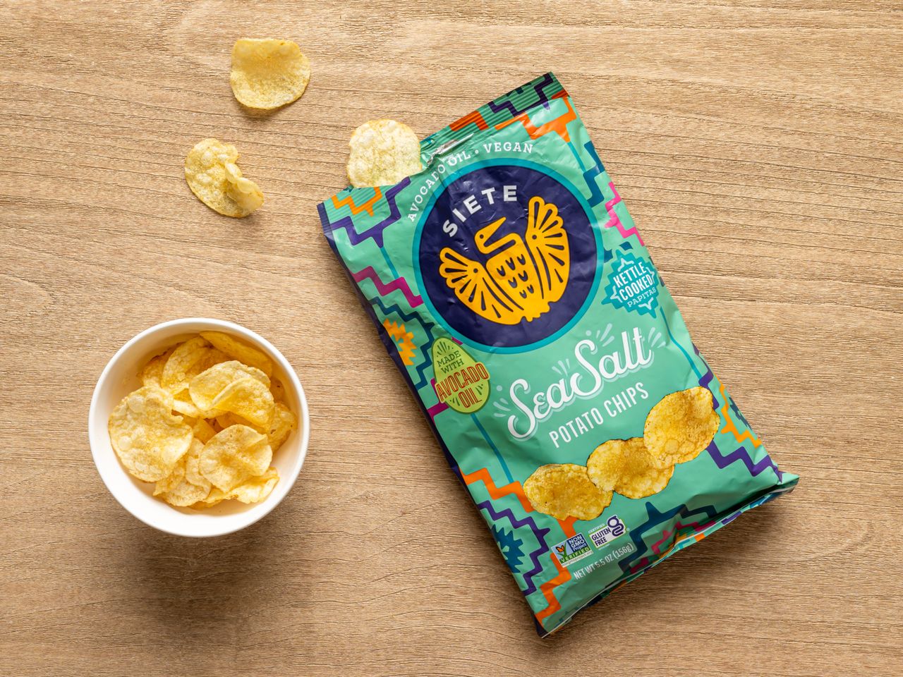 A bag of Siete sea salt potato chips with a small bowl of chips