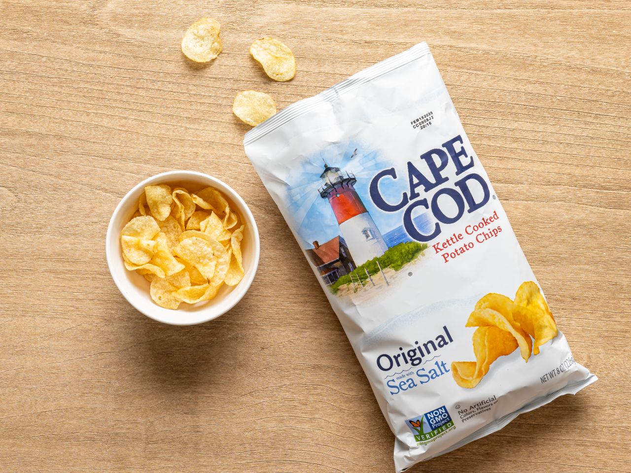 A bag of Cape Cod kettle cooked sea salt potato chips with a small bowl of chips