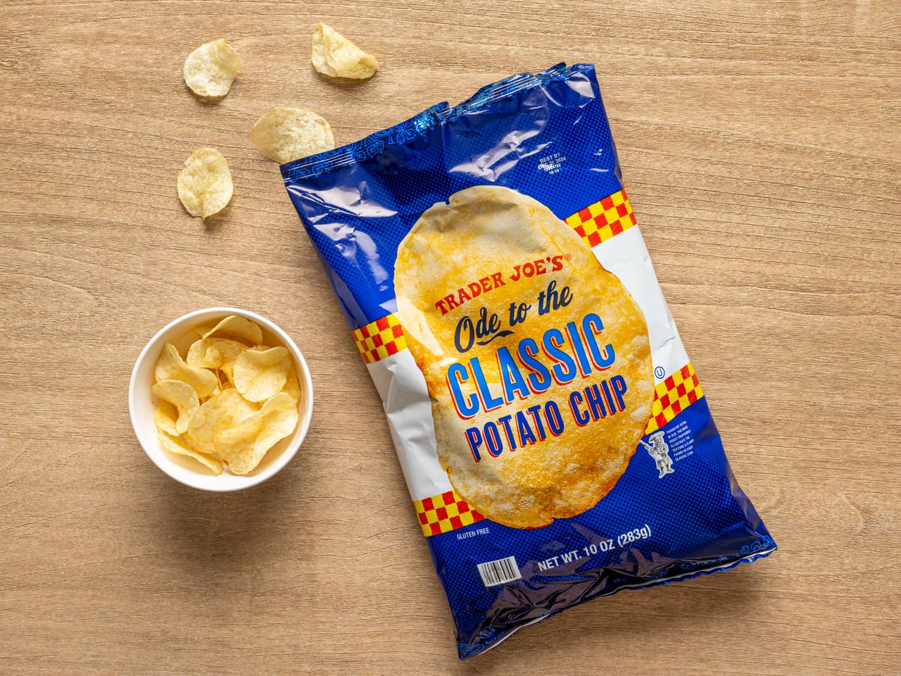 A bag of Trader Joe's Ode of the Classic Potato Chip with a small bowl of chips