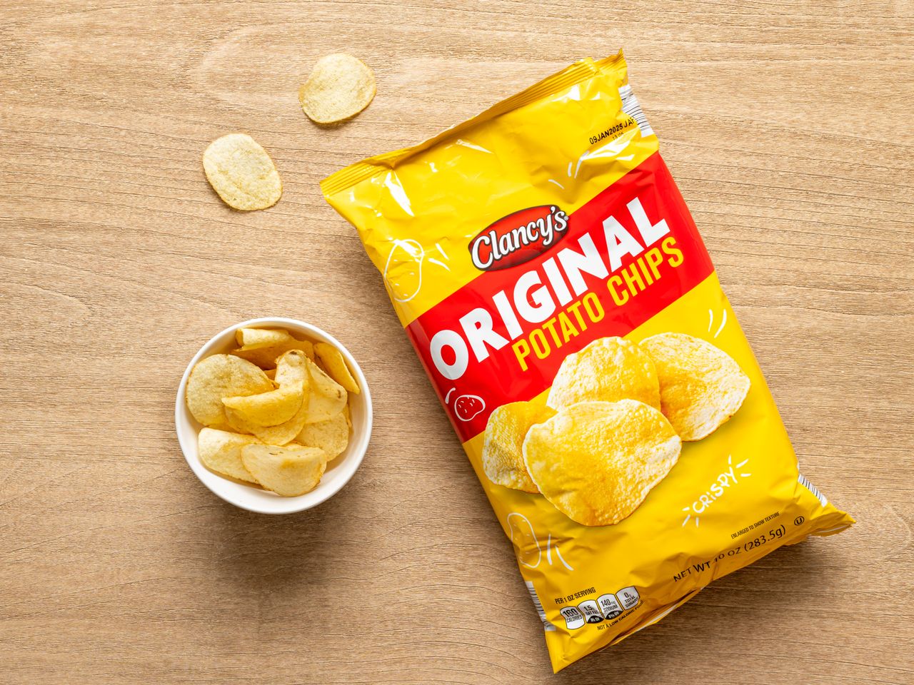 A bag of Clancy's original potato chips with a small bowl of chips