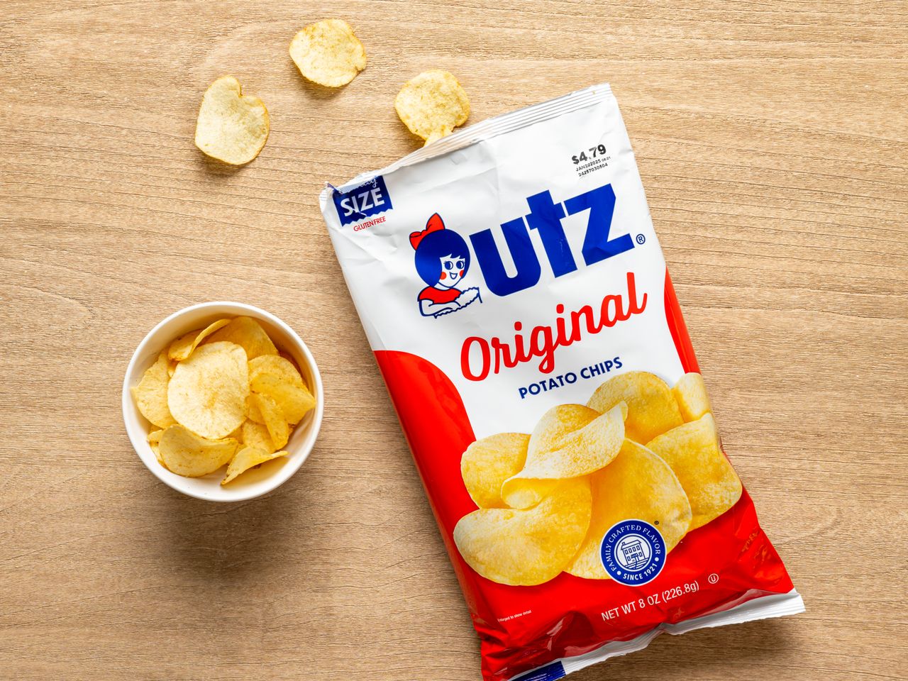 A bag of Utz Original Potato Chips with a small bowl of chips