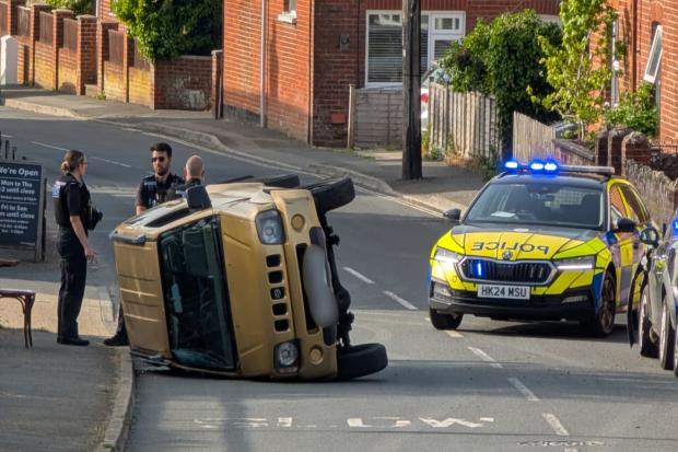 Injury after car flipped on its side in high street crash