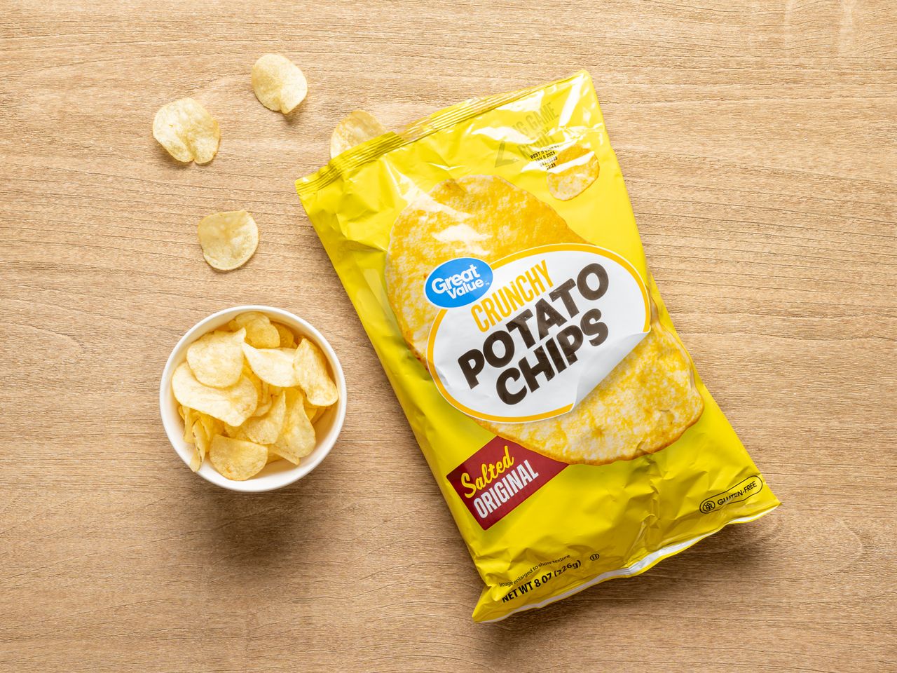 A bag of Great Value Crunchy Potato Chips Salted Original with a small bowl of chips