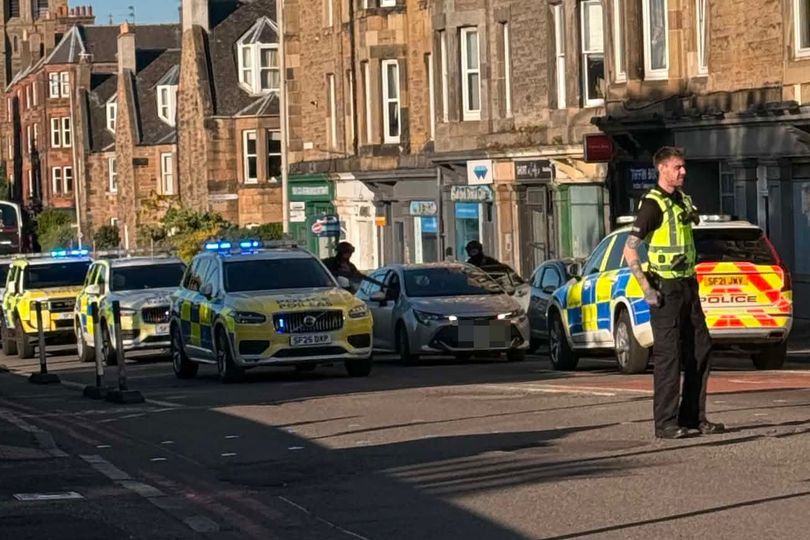 Armed police lockdown Edinburgh road amid ongoing incident as traffic ...