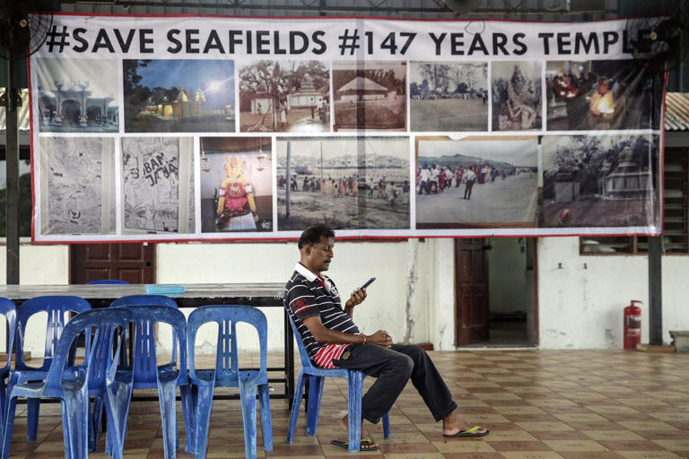 A man sits outside the Sri Maha Mariamman temple in Subang Jaya, Selangor, before its relocation in November 2018. Photo: EPA-EFE