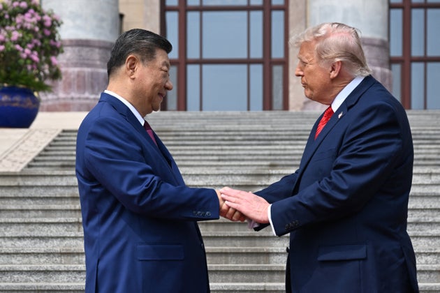 Above, President Donald Trump shakes hands with China's President Xi Jinping at the Great Hall of the People in Beijing.