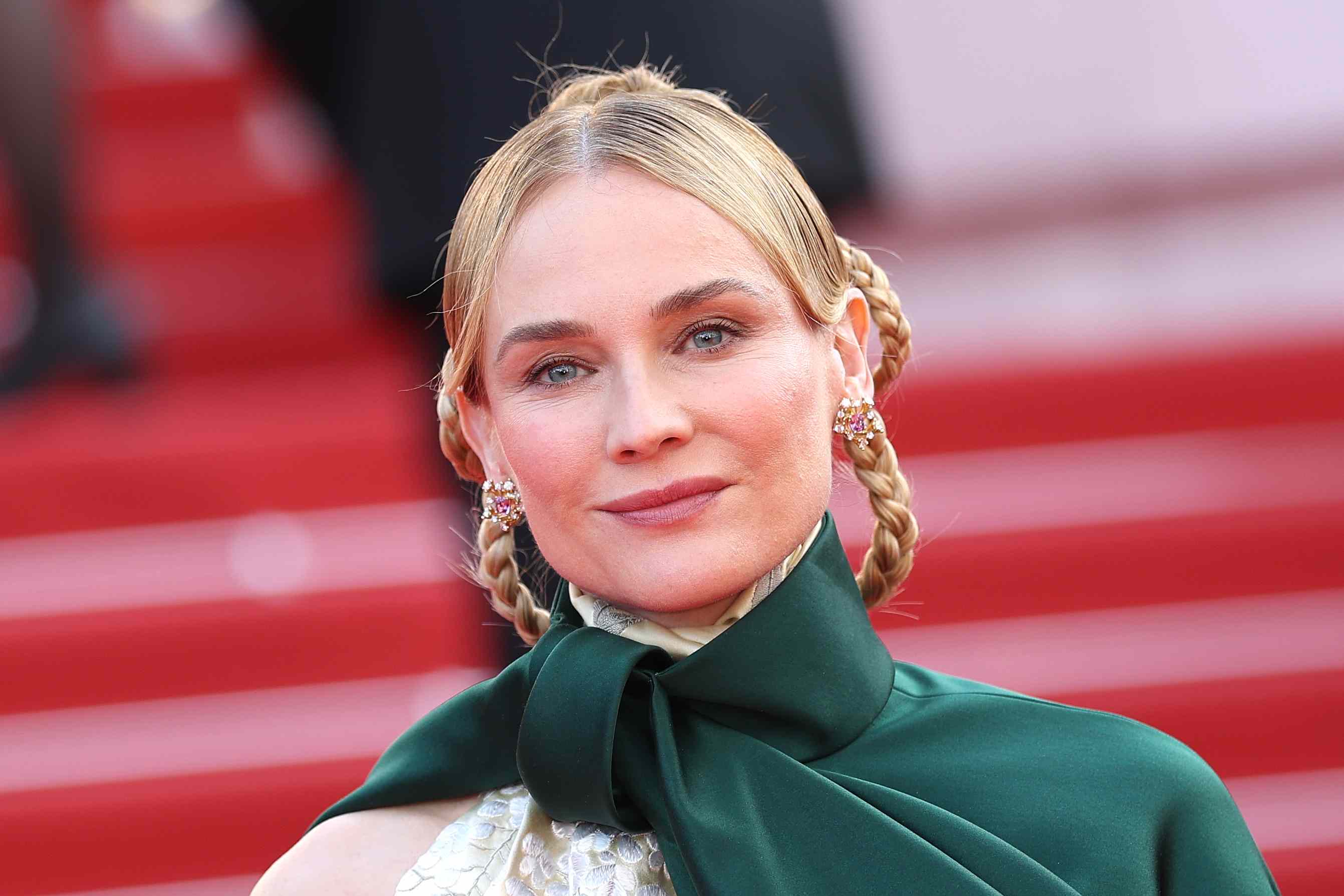 Diane Kruger pairs sculptural hairstyle with a dramatic cape that's a ...