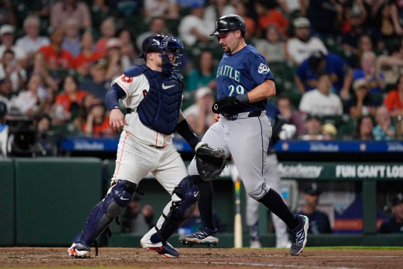 Mariners' scuffling star catcher Cal Raleigh placed on 10-day injured ...