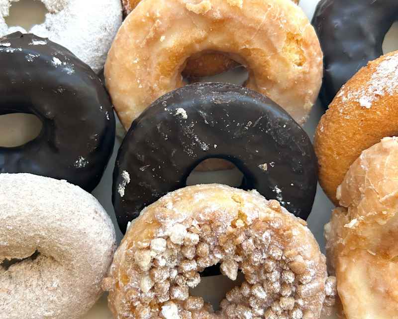 Various types of entenmann's donuts displayed.
