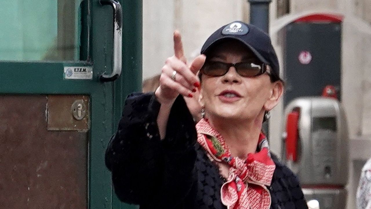 Catherine Zeta-Jones elevates her straight-leg jeans with a neckerchief and designer trainers