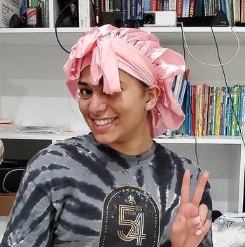 reviewer posing wearing bonnet in pink