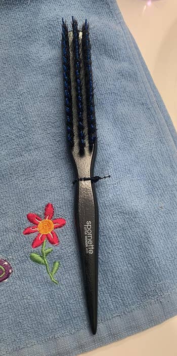 a reviewer photo of the teasing brush