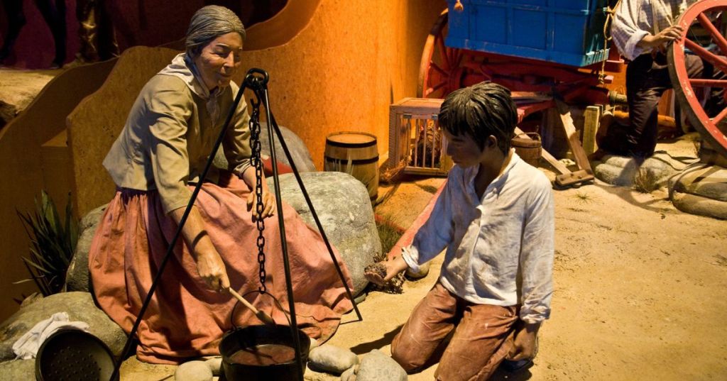 An exhibit of early settlers cooking in a hanging pot, at the National Historic Trails Interpretive Center in Casper, WY.