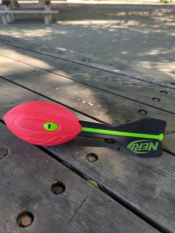 Nerf Vortex Aero Howler toy lying on a wooden picnic table outdoors