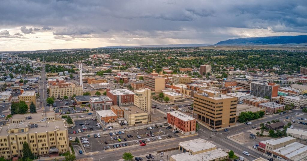 Aerial views of Casper, Wyoming, featuring a busy downtown with lots of buildings and rolling hills in the distance.