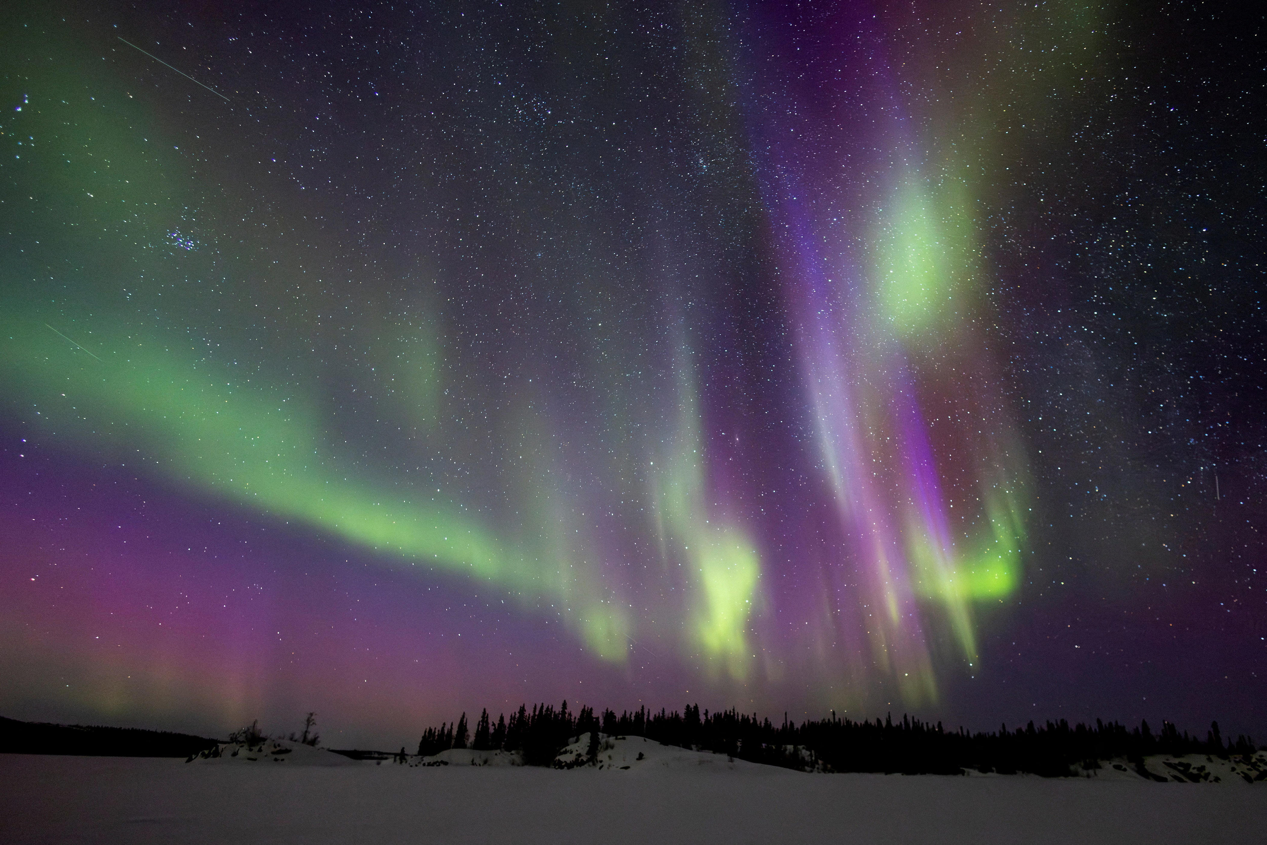 The aurora borealis, also known as the northern lights, over the frozen Prosperous Lake near Yellowknife, Northwest Territories, Canada, March 13, 2026.