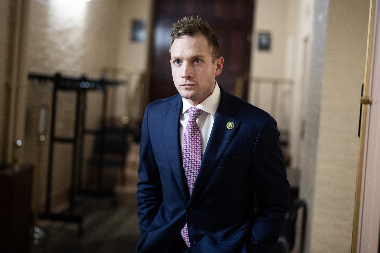 Max Miller standing with his hands in his pockets in a Capitol hallway.