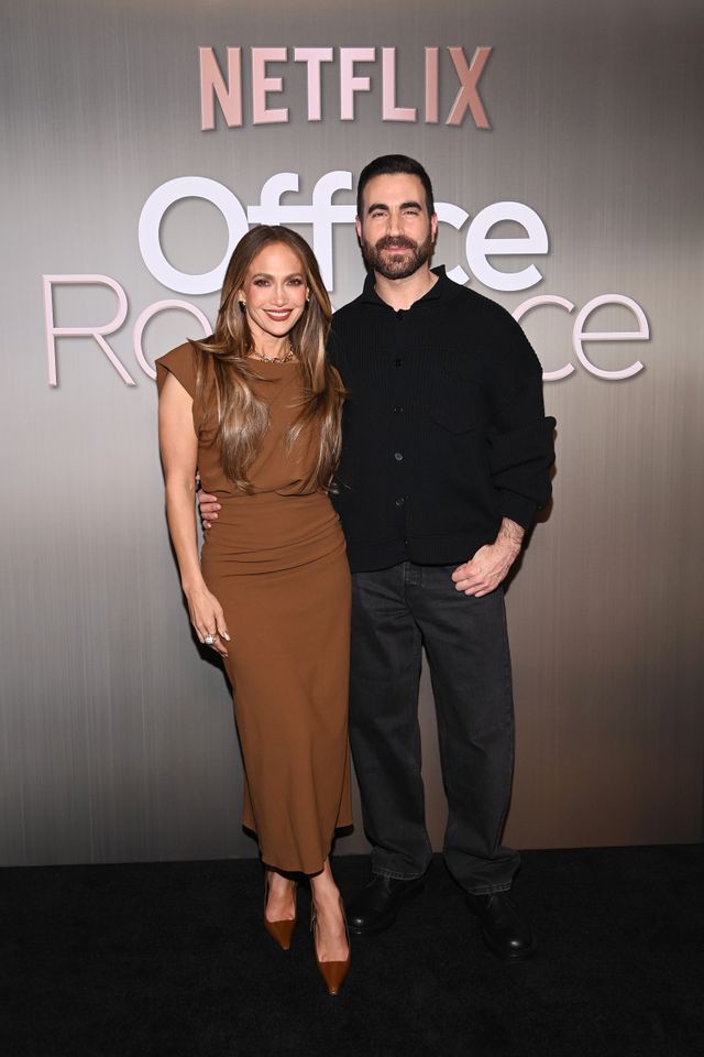 Jennifer Lopez means business in a coppery figure-hugging dress and a  cinched coat