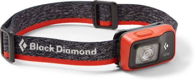 red and black Black Diamond headlamp with adjustable strap and LED light