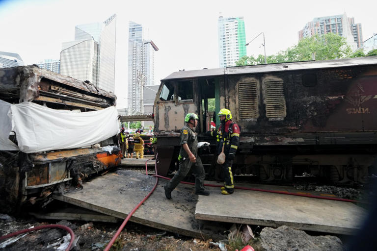 A cargo train hits a public bus at a Bangkok rail crossing, killing at ...