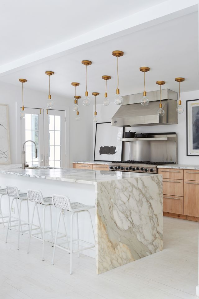 Modern kitchen with marble island and bar stools