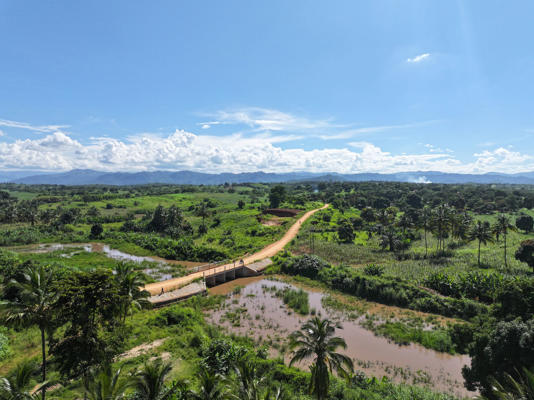 The escalating climate crisis is undermining World Vision’s work, such as this new bridge that is already under threat from flooded rivers (Alpha Nsemwa/World Vision)