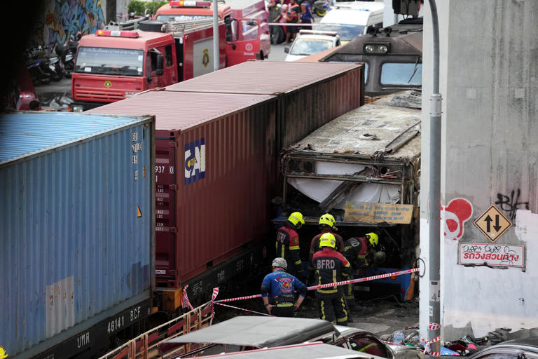 A cargo train hits a public bus at a Bangkok rail crossing, killing at ...