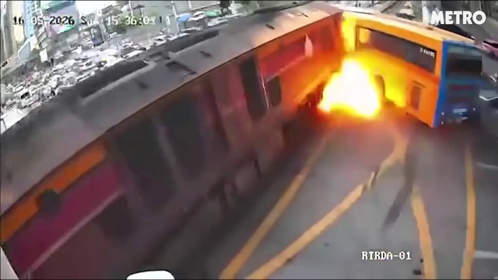 Bus explodes in fireball killing eight after train crashes into it in Thailand