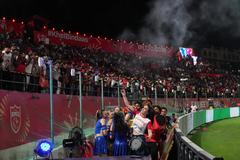 Punjab Kings co-owner Preity Zinta throws T-shirts to fans during the Indian Premier League cricket match between her team and Mumbai Indians in Dharamshala, India, on Thursday. Photo: AP