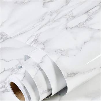 Rolls of marble-patterned contact paper, ideal for DIY projects and home decor