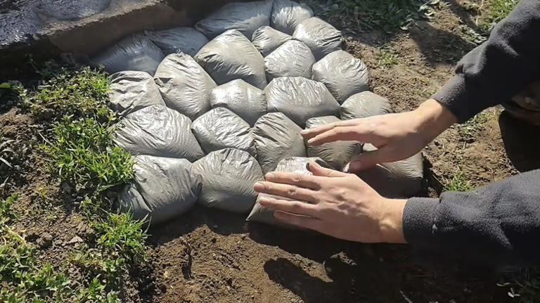 Use plastic bags to create a budget-friendly cobblestone path with this ...