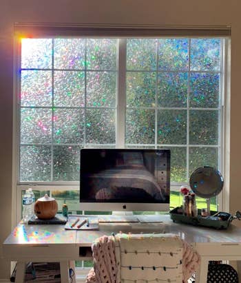 reviewer's desk with window behind it that has the film installed