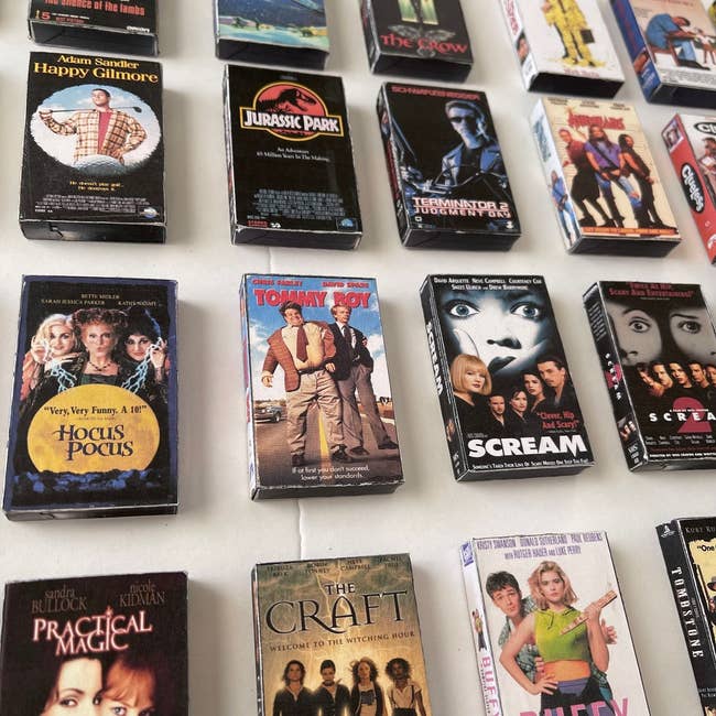 Assorted classic VHS movie covers are spread out, including