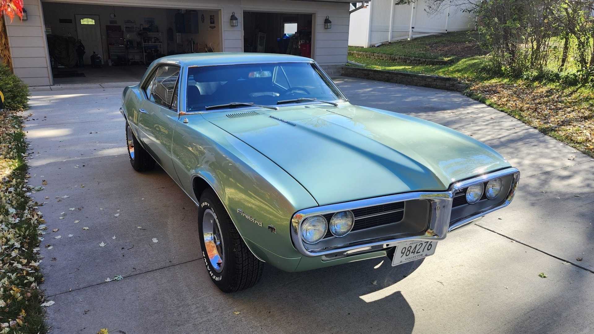 The front of a classic 1960s Pontiac muscle car parked in a driveway