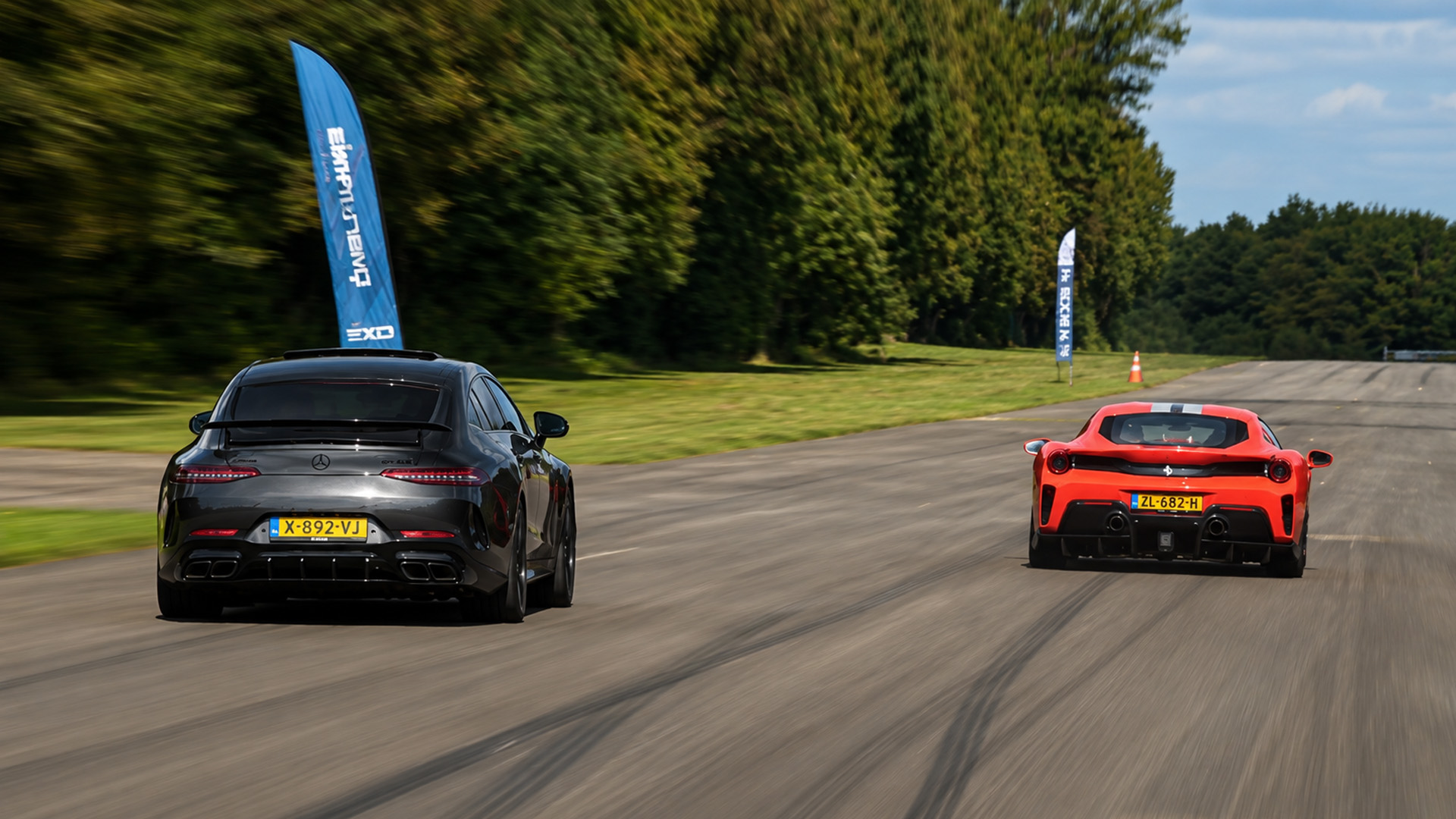 Intense drag race tests luxury car against supercar