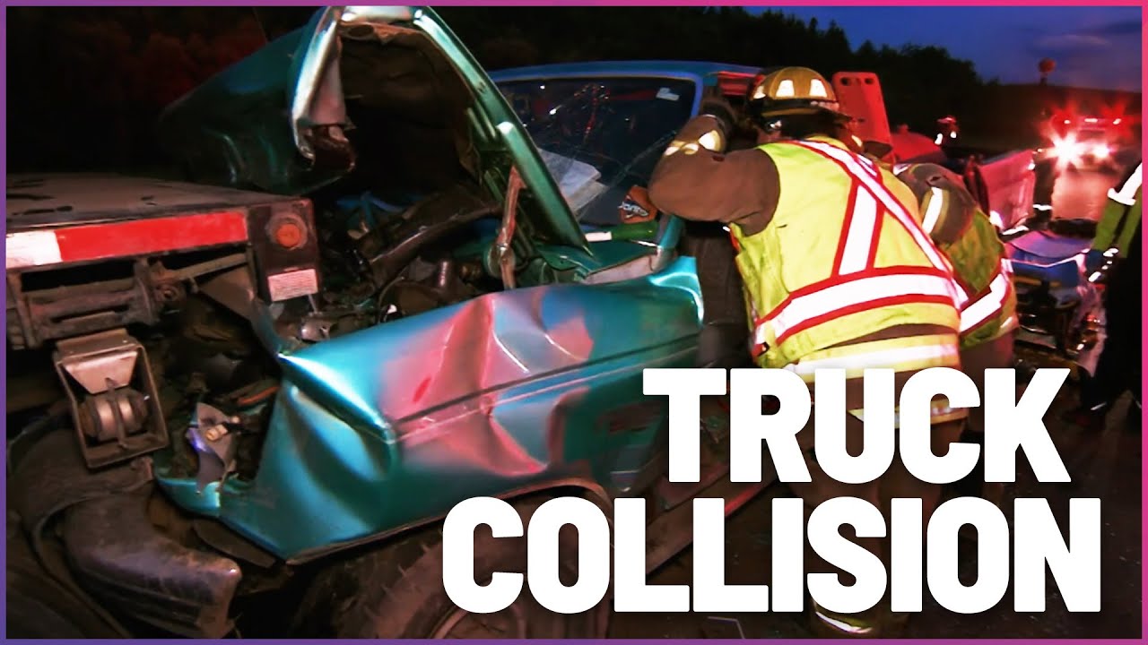 Firefighters rush to rescue a car crash victim from a mangled truck ...