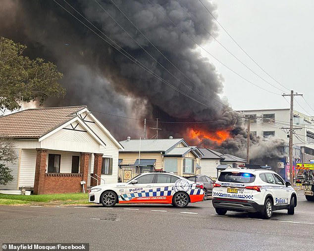 Police has closed off parts of the suburb of Mayfield with more than 60 firefighters battling the inferno