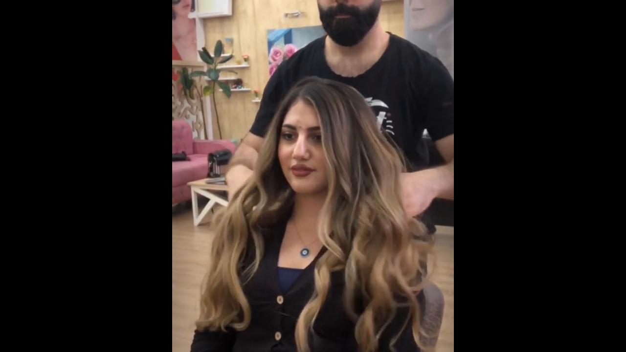Styling extra long layered hair with loose curling motion producing ...