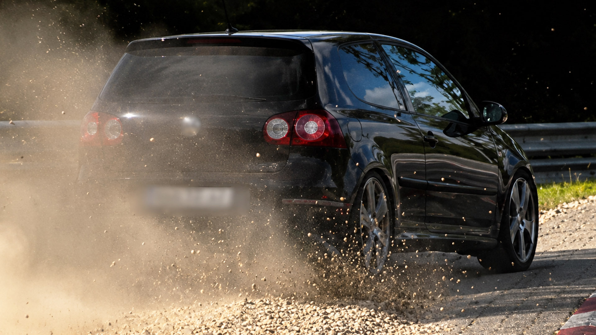 Dust and stones fly as the driver pushes through Nordschleife