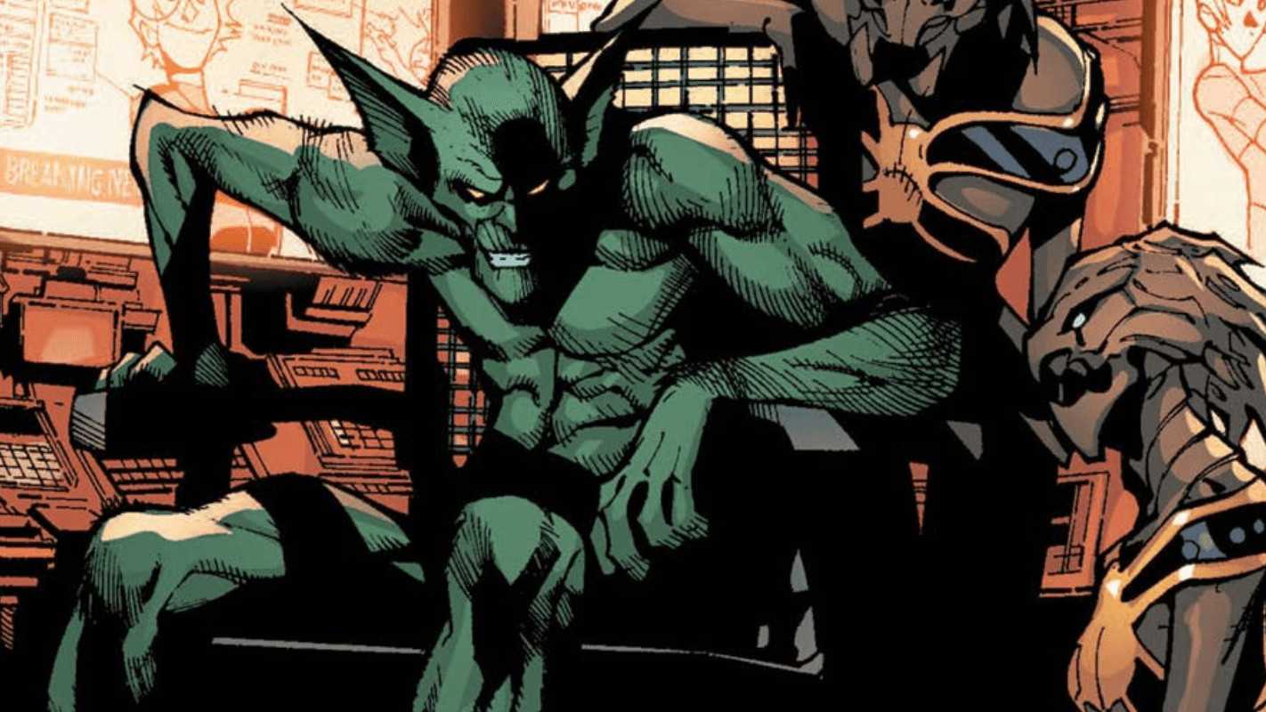 Dr. Miles Warren a.k.a. Jackal grinning while sitting in a chair