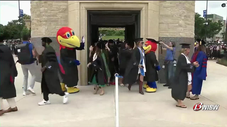 KU graduates march through Memorial Campanile Sunday