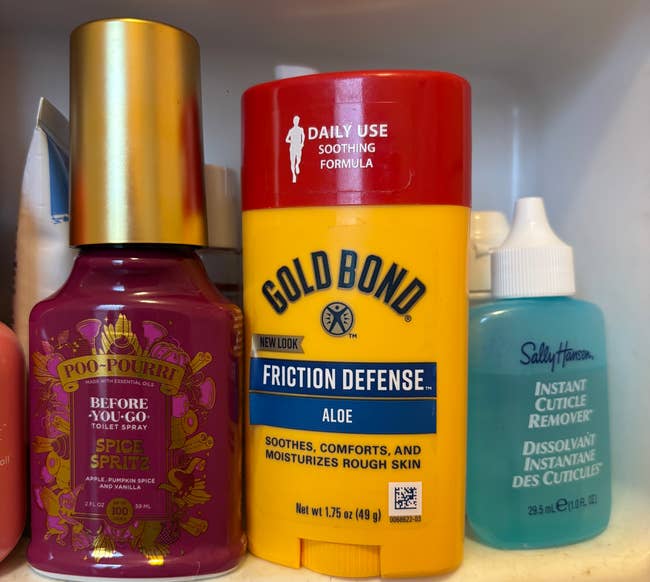 Shelf with Poo-Pourri spray, Gold Bond Friction Defense, and Sally Hansen Cuticle Remover