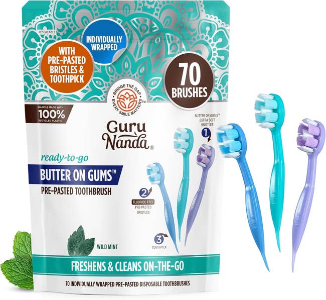 Package of Guru Nanda pre-pasted disposable toothbrushes with three toothbrushes shown. Includes mint leaves and highlights 70 brushes for travel use