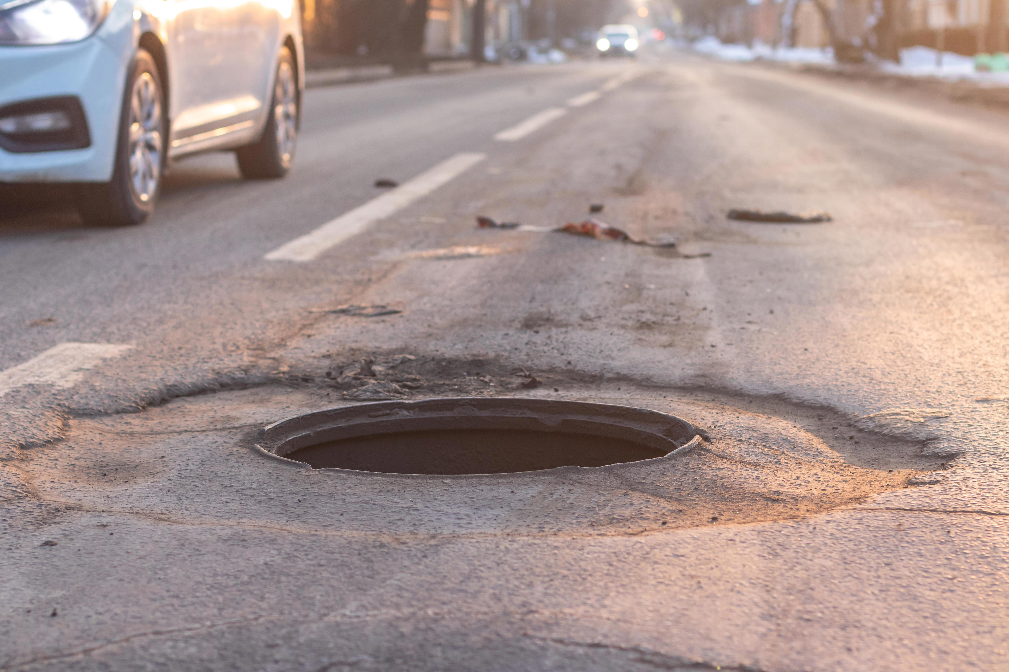 Woman dies after stepping out of car and falling down uncovered manhole