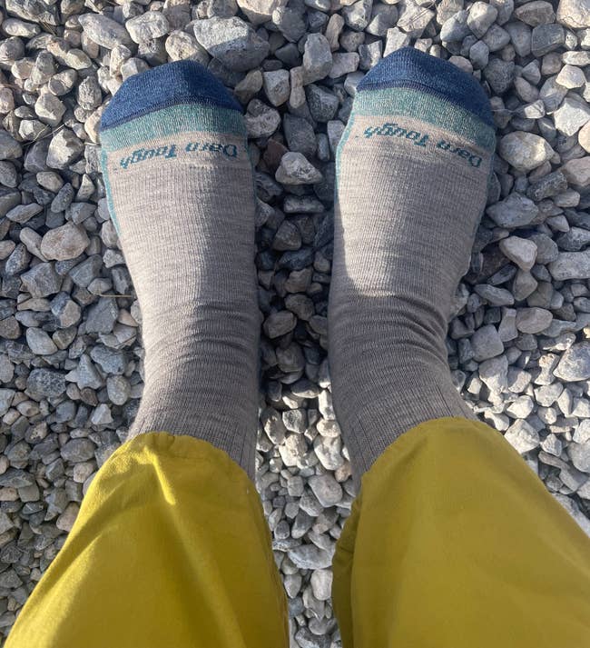 the writer in grey and blue darn tough socks