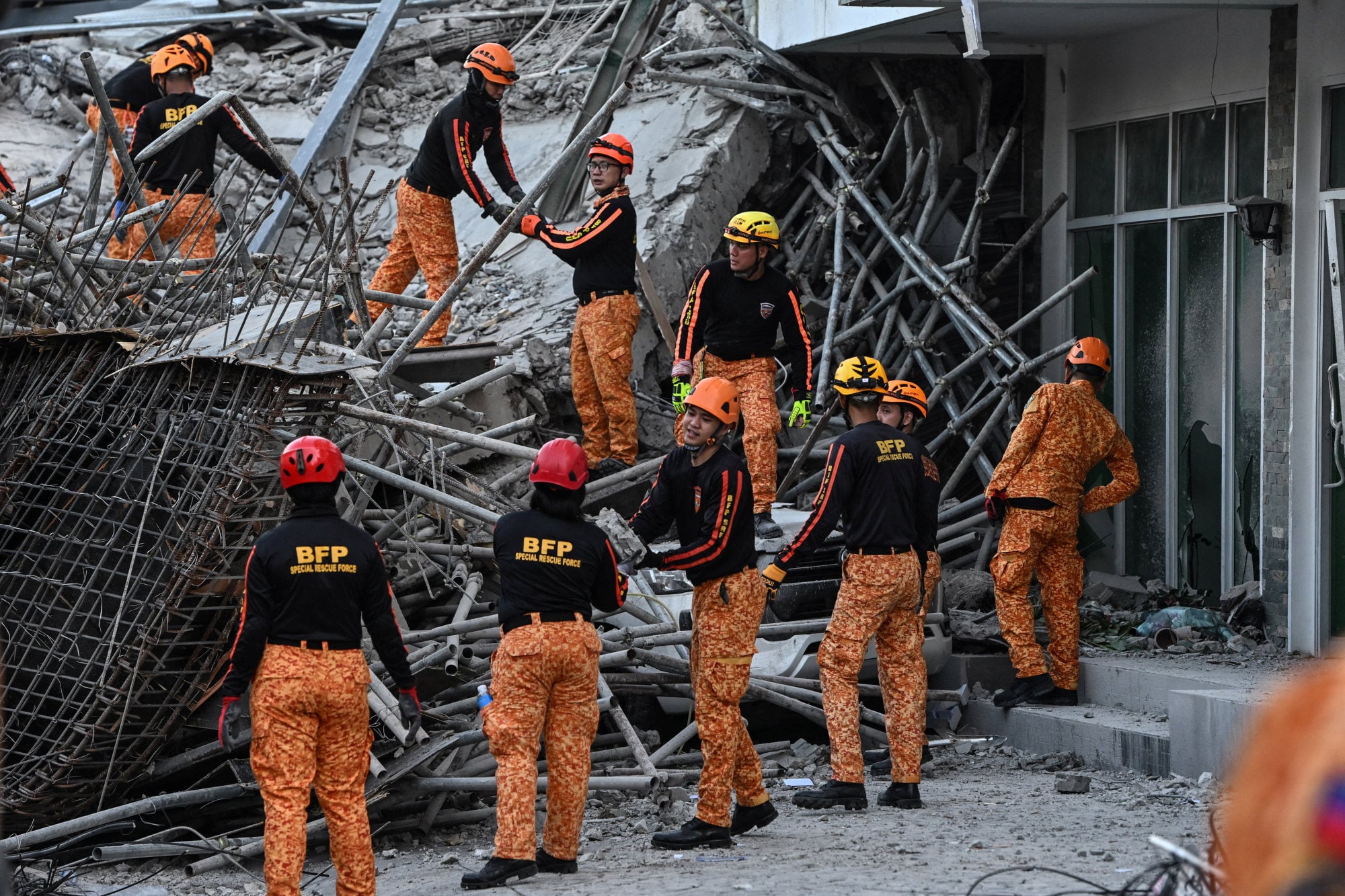 Philippine rescuers race to free workers trapped after hotel collapse
